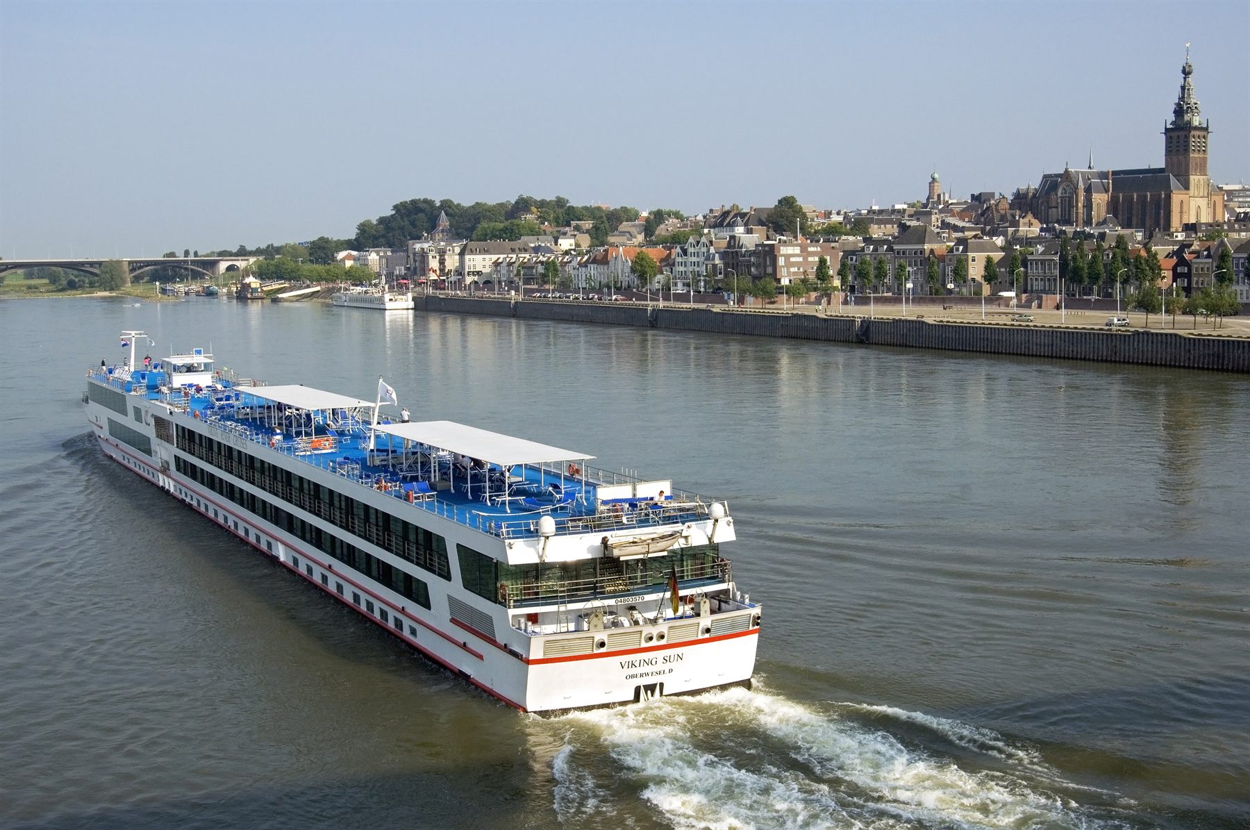Viking Sun river cruise ship on the Waal at Nijmegen, the Stevenskerk tower behind